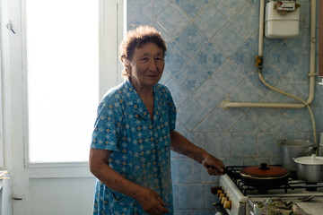 Elderly woman in home kitchen