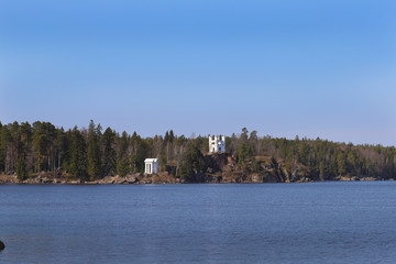 Rocky shores of the Gulf of Finland of the Baltic Sea with small white buildings located on them
