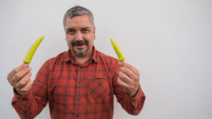 Latin man holding chilean chili pepper with his hands.