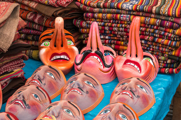 Traditional festival masks, craft market of Pisac, near Cusco, Peru. - obrazy, fototapety, plakaty