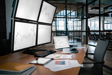 Stock Trading. Trader workplace isolated no people desk in front of monitors with price flow chart