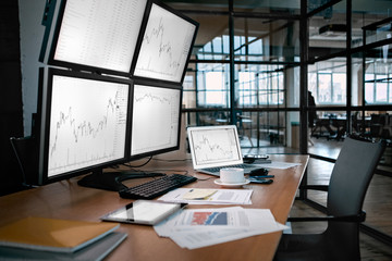 Stock Trading. Trader workplace isolated no people desk in front of monitors with price flow chart