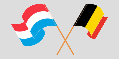 Crossed and waving flags of Luxembourg and Belgium
