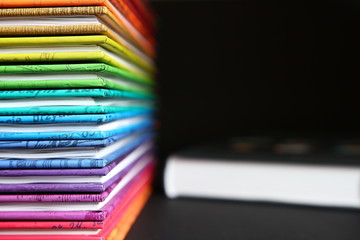 Education - pile of books with colorful covers on dark background