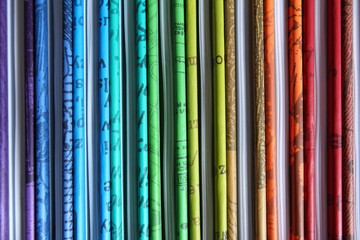 Books with colored covers arranged in the color of the rainbow - background