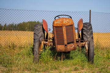 Old tractor standing on the field