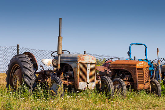Old tractors standing on the field