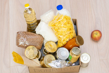 Fototapeta na wymiar Food donations. canned food, pasta and cereals cardboard box. or food delivery concept.
