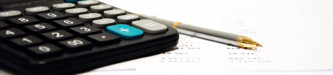 money calculator and pen lie on the table