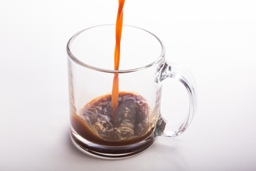 Black Coffee Poured in glass mug on white surface