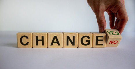 Hand turns a cube and changes the expression 'change no' to 'change yes'. Beautiful white...