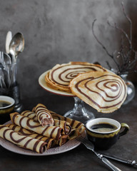 Crepes. Pancakes with chocolate stripes. Rolled striped pancakes. Maslenitsa. Zebra pancakes with...