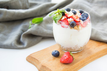 Healthy blueberry, strawberry and walnut parfait in a glass 