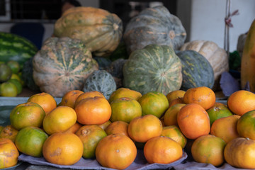 Tangerine and pumpkin at a street market for sale. Colombia.
