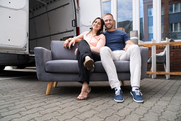 Couple Moving Couch Or Sofa Together