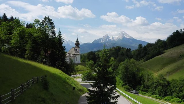 Aerial fly towards church Maria Gern, Mount Watzmann in background, Berchtesgaden, Bavaria, Germany, Europe