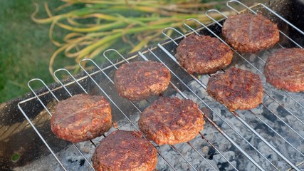 Beef and Pork Patty for Burger. Cooking Cutlets on Mangal. Grill Minced Meat. Chef Cooks burger in street outdoors. Summer Picnic in Nature. Tasty Meat Dish. Closeup