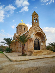Fototapeta na wymiar View of St. John the Baptist Greek Orthodox Church, located at the site of the baptism of Jesus Christ on the Jordan River. Blue sky with some clouds.