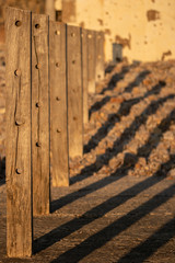 Fence post shadows in the evening