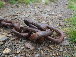 Close up of old rusty chain on the ground in the lake district