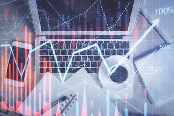 Stock market chart and top view computer on the table background. Double exposure. Concept of financial analysis.