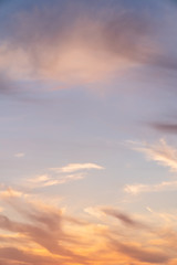 Beautiful bright sunset. Soft colors of clouds and sky. Quiet background. Orange and blue colors. Vertical photo