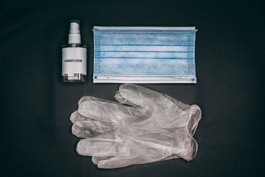 A Small  Bottle Of Hand Sanitizer With  Mask And Gloves 