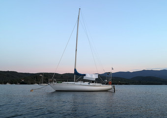 A sailboat anchored in a bay