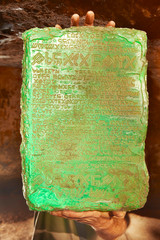 Detail of mysterious artifact emerald tablet found by adventurer in cave