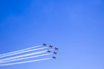 Airshow with planes in the cloudy sky.  A group of aircrafts on open for the public air show