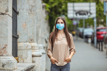 Student girl holding books while walking to school. She wears a mask for COVID-19, Corona virus protection. Back to school. Back to school with the face mask