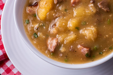.Cassava broth. Creamy broth made with cassava, sausage, bacon and meat. Top view