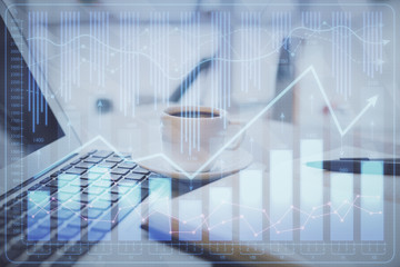 Double exposure of financial chart drawing and desktop with coffee and items on table background. Concept of forex market trading