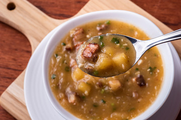 .Cassava broth. Creamy broth made with cassava, sausage, bacon and meat. Top view