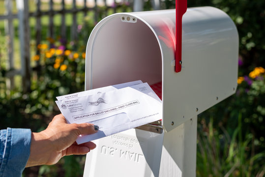 Barrington, IL/USA - 08/22/2020:  Homeowner receives applications for mail-in ballot for 2020 presidential election via US Postal Service