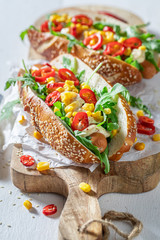 Delicious hot dogs with arugula, corn and chilli pepper