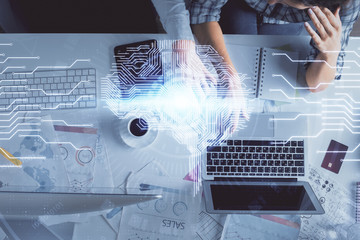 Double exposure of man and woman working together and human brain hologram drawing. Brainstorm concept. Computer background. Top View.