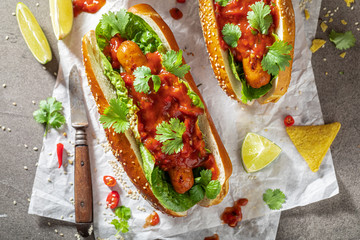 Spicy barbecue hot dogs served with nachos and lemonade