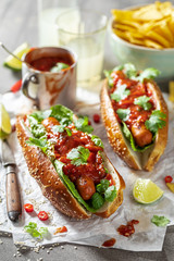 Spicy barbecue hot dogs with with sauce and grilled sausage