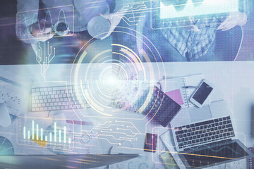 Double exposure of man and woman working together and data theme hologram drawing. Computer background. Top View.