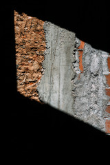 Vertical shot of the sunlight falling on a wall with cement