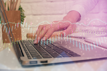 Multi exposure of woman hands typing on computer and forex chart hologram drawing. Stock market analysis concept.