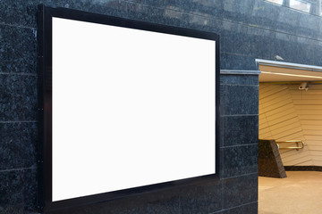 Large horizontal billboard on the wall with granite tiles in the underpass.