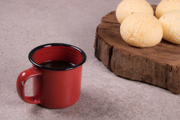cup of coffee with cement background accompanies cheese bread