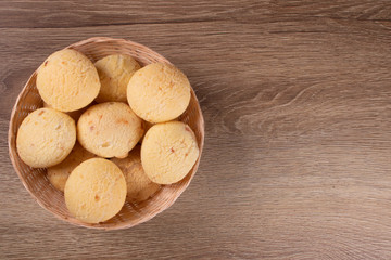 Brazilian cheese bread basket on wooden background