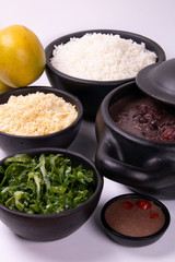 complete feijoada with rice, beans, cabbage, farofa, orange and pepper
