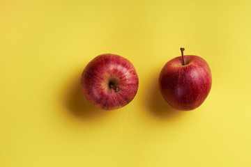 ripe red apples on a yellow background.selective focus