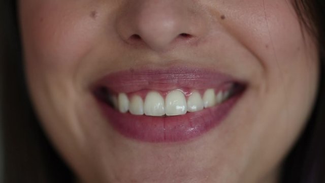 Woman lips smiling at camera. Pretty girl smile white teeth close-up
