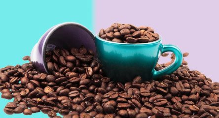 Cups of coffee with beans in and spilled around with pastel colors