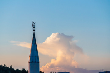 Mosque, minarets against a sunset time in clouds with lightning rod